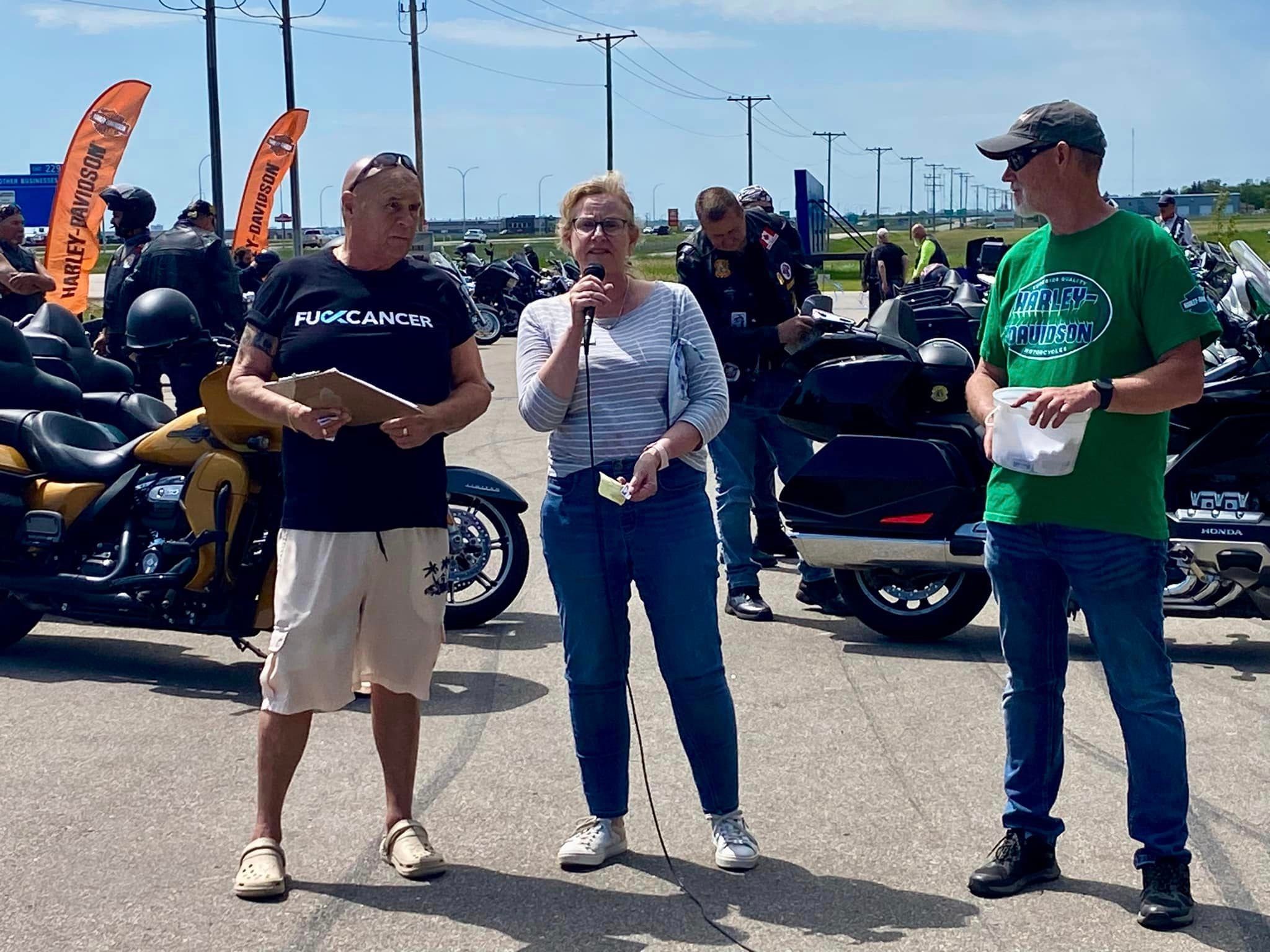 Chapter members addressing riders at a charity ride event