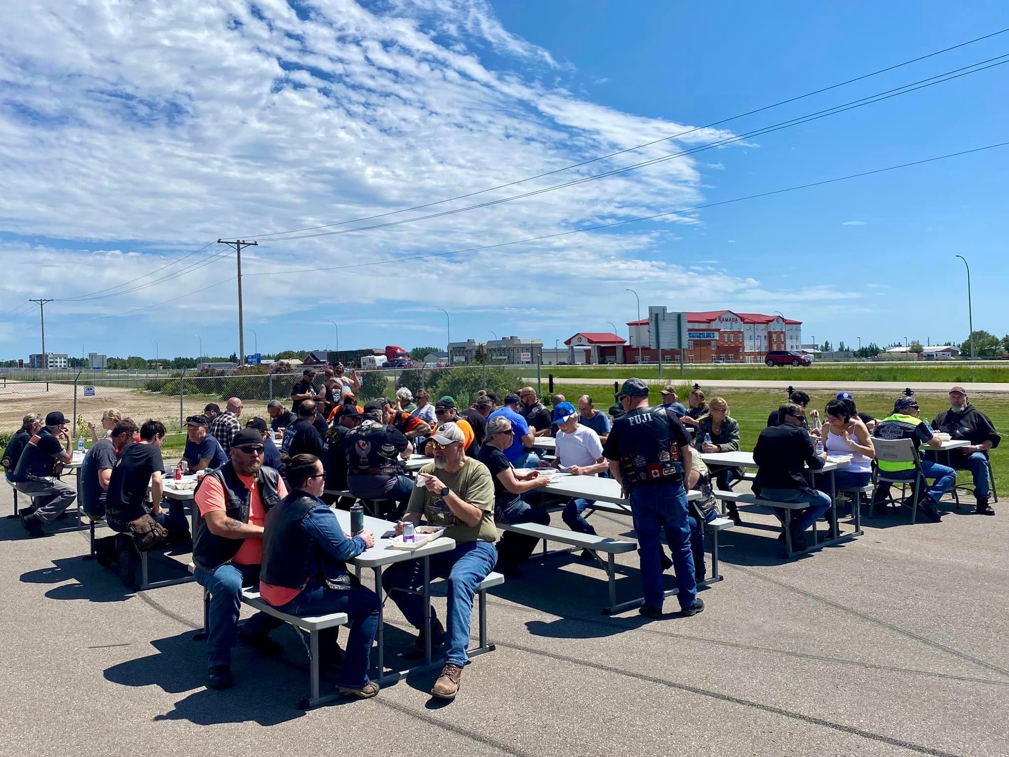 Chapter members gathered at picnic tables for an outdoor meal