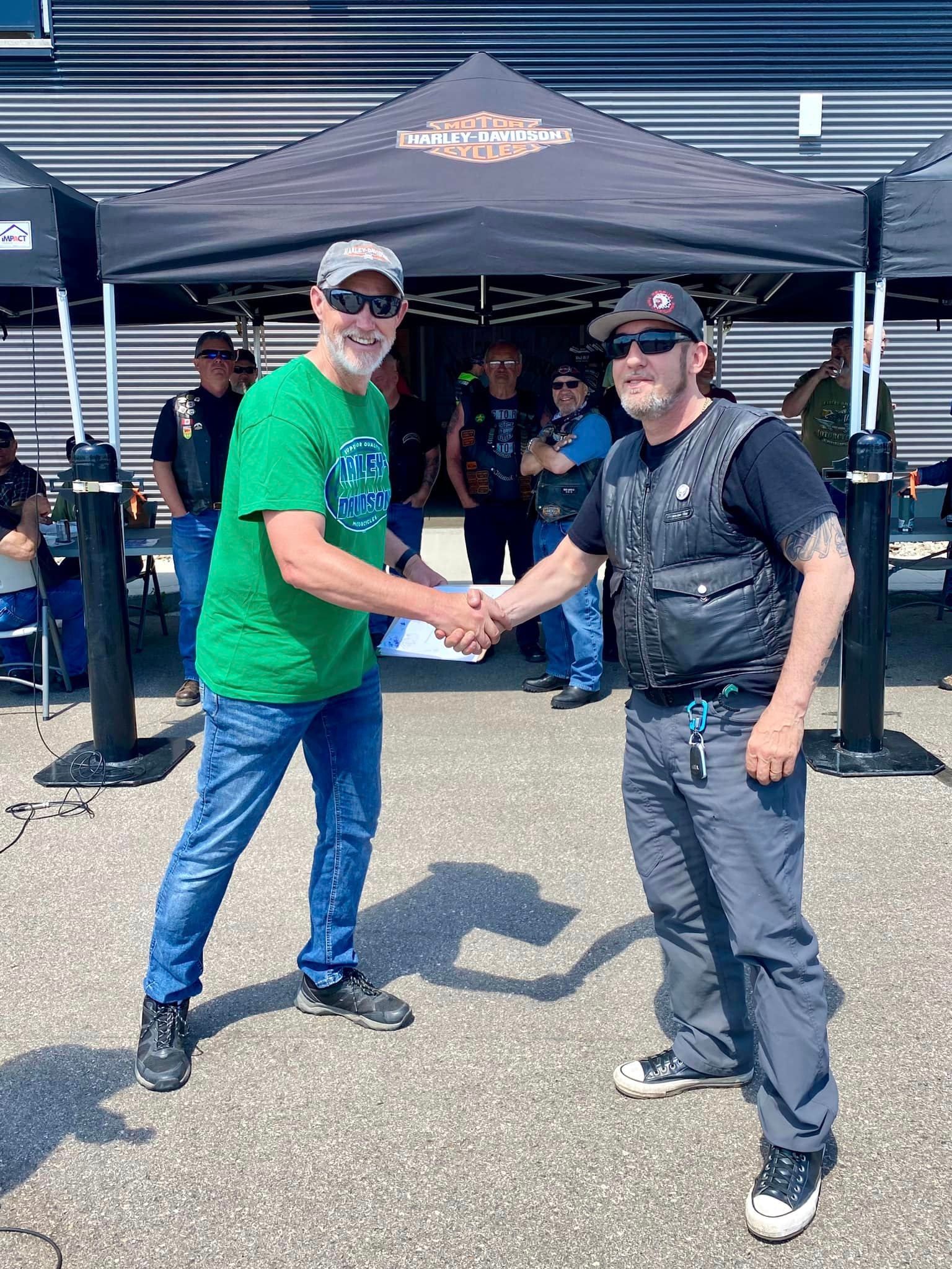 Men shaking hands at a Regina HOG chapter charity event