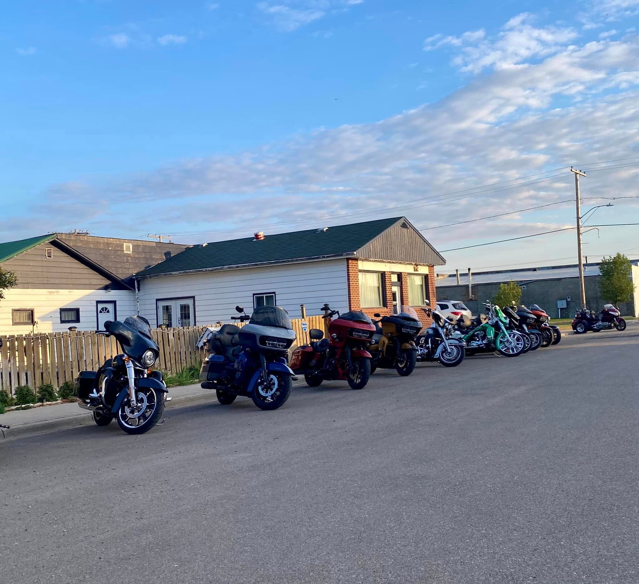 Bikes lined up outside a residential stop on a chapter ride