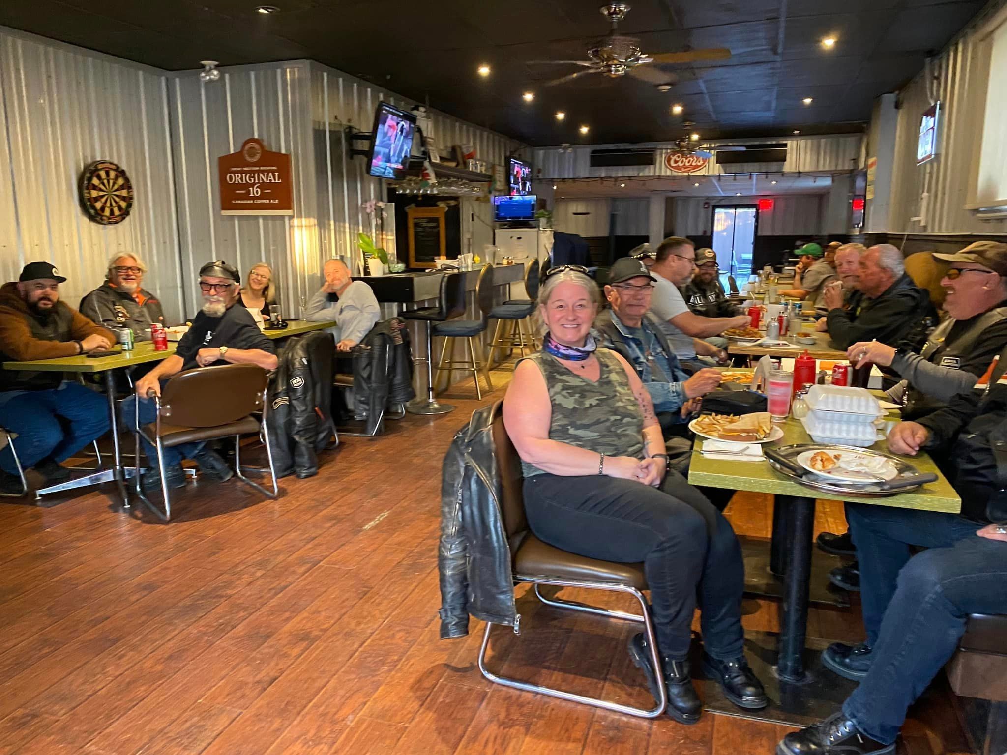 Large group of chapter members dining together inside a bar and grill