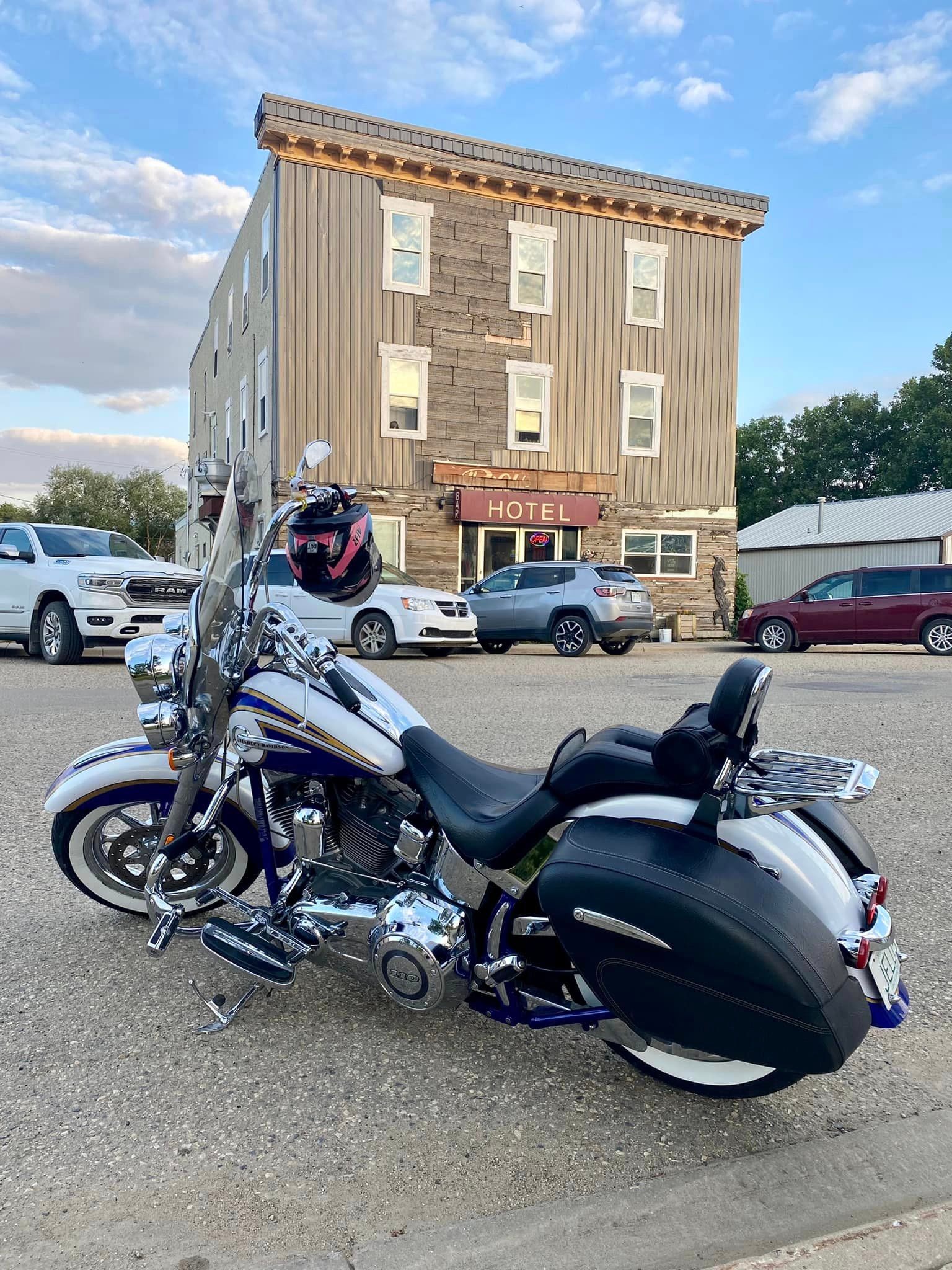 Classic Harley-Davidson parked in front of a historic prairie hotel