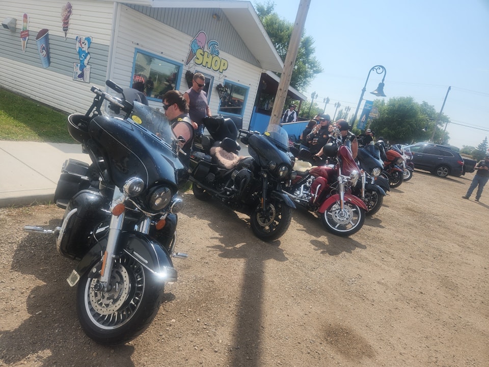 Bikes lined up outside The Shop ice cream stand on a sunny chapter ride