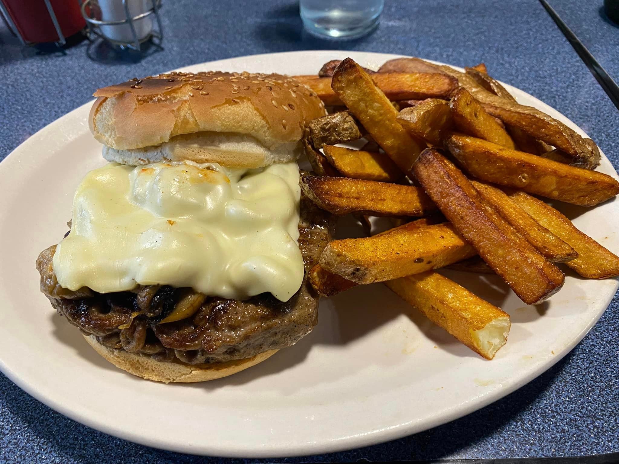 Mushroom Swiss burger with thick-cut fries at a chapter ride stop
