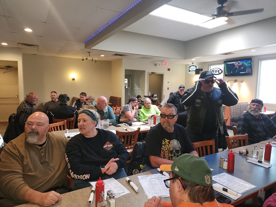 Chapter members filling a bright diner for a group breakfast on a 2024 ride