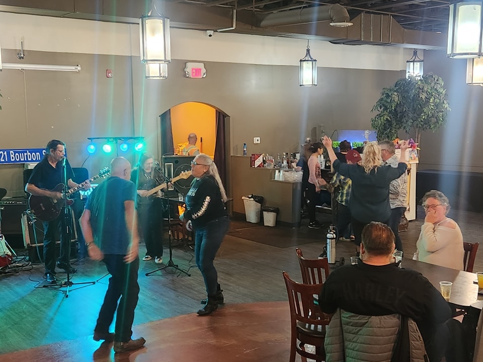 Live band performing on stage with members dancing at a chapter social event
