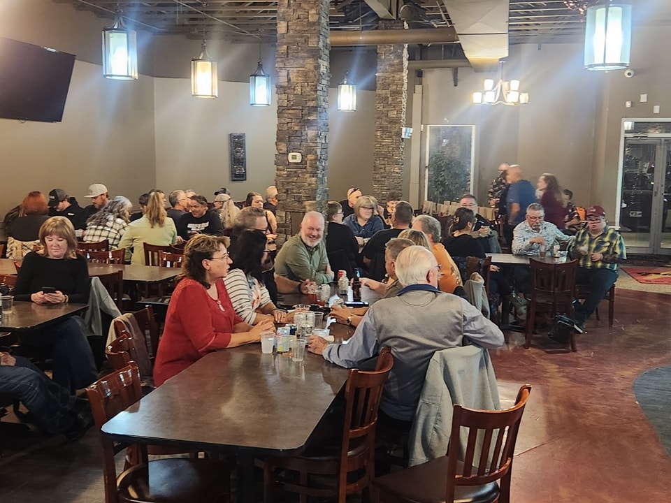 Large group of chapter members filling a restaurant for a chapter social dinner