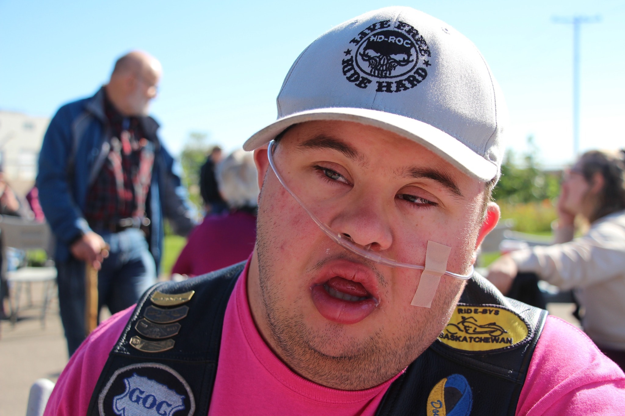 Chapter member in a pink shirt and HD-ROC cap at the 2024 Breast Cancer Awareness Ride