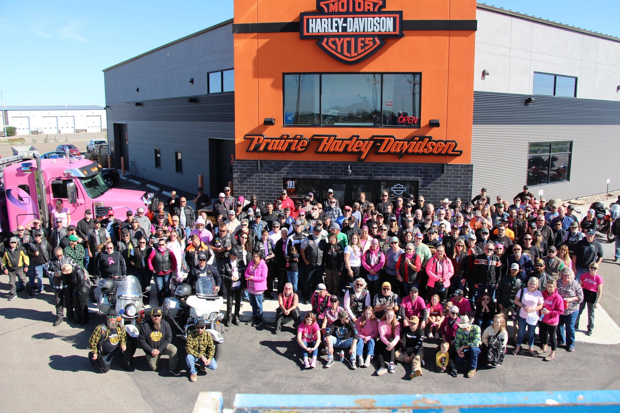 Massive group photo of riders in front of Prairie Harley-Davidson for the 2024 Breast Cancer Awareness Ride